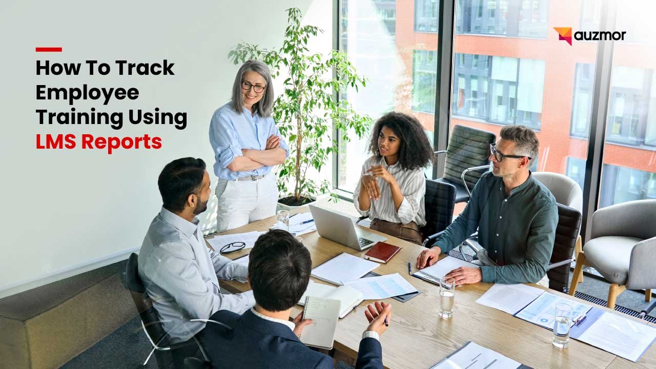 Team meeting around a table with laptops, with the title How To Track Employee Training Using LMS Reports