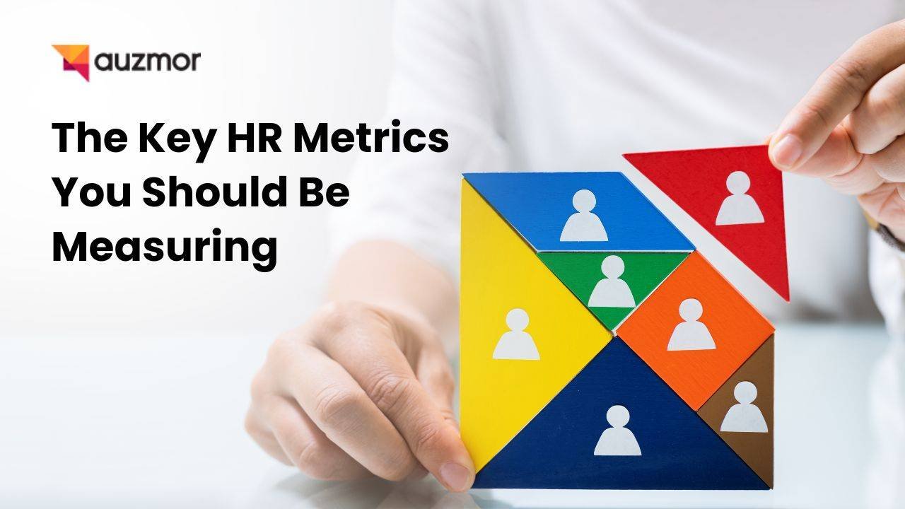 Hand arranging colourful people-icon blocks, with the title The Key HR Metrics You Should Be Measuring