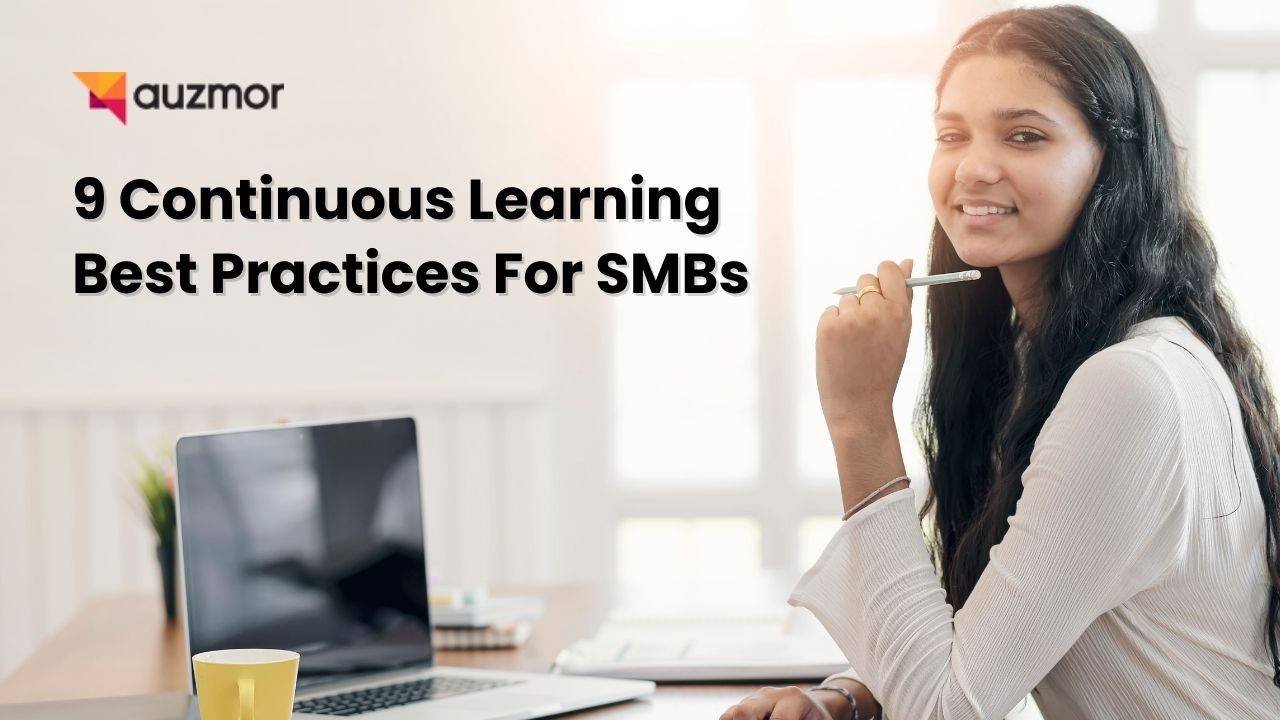 Smiling woman holding a pen at a desk with a laptop, with the title 9 Continuous Learning Best Practices For SMBs