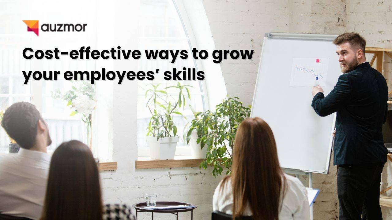 Trainer presenting at a flip chart to colleagues, with the title Cost-effective ways to grow your employees' skills
