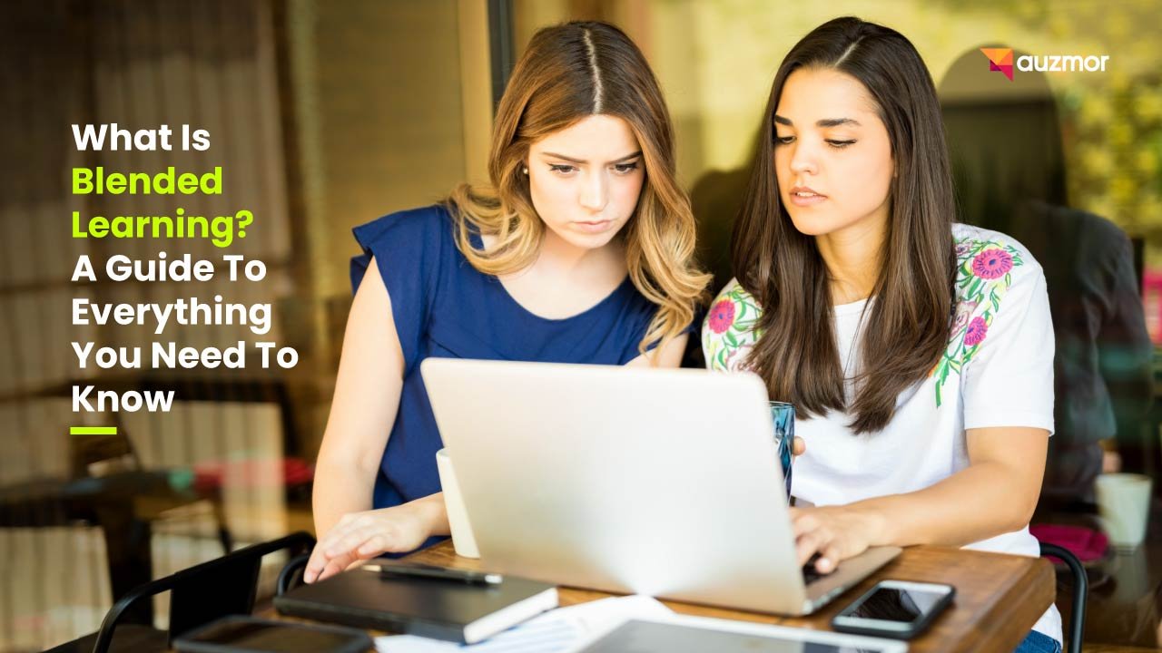 Two young women studying together at a laptop, with the title What Is Blended Learning? A Guide To Everything You Need To Know