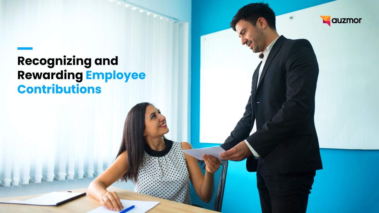 Manager handing a document to a smiling employee at her desk, with the title Recognizing and Rewarding Employee Contributions