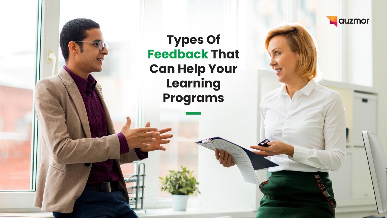 Two colleagues discussing a document, with the title Types of Feedback That Can Help Your Learning Programs
