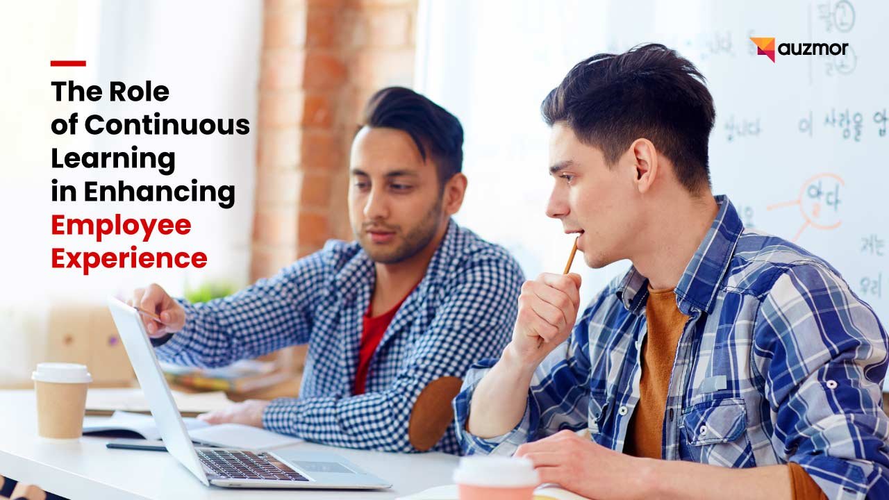 Two young men studying together at a laptop, with the title The Role of Continuous Learning in Enhancing Employee Experience