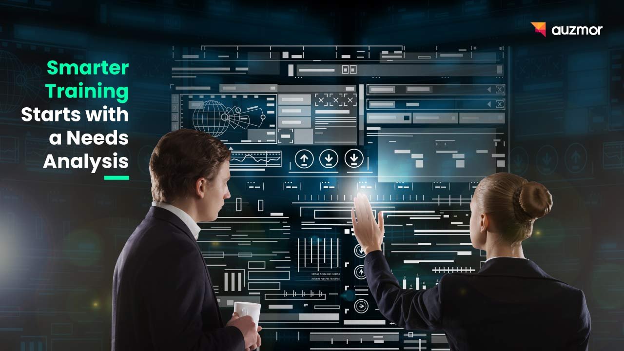 Two colleagues at a wall of data screens, with the title Smarter Training Starts with a Needs Analysis