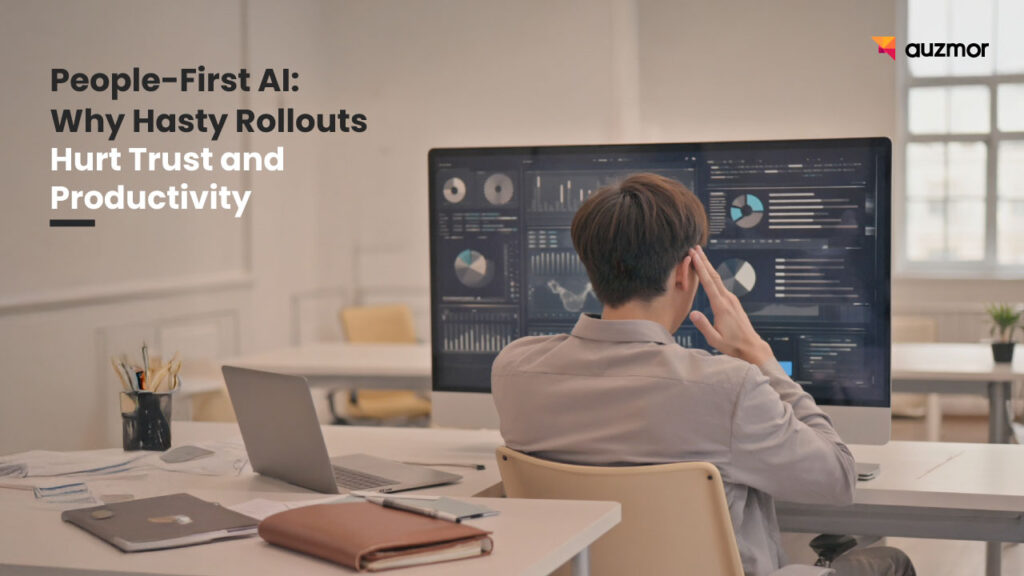 Man at a desk with his head in his hand in front of dashboards, with the title People-First AI: Why Hasty Rollouts Hurt Trust and Productivity