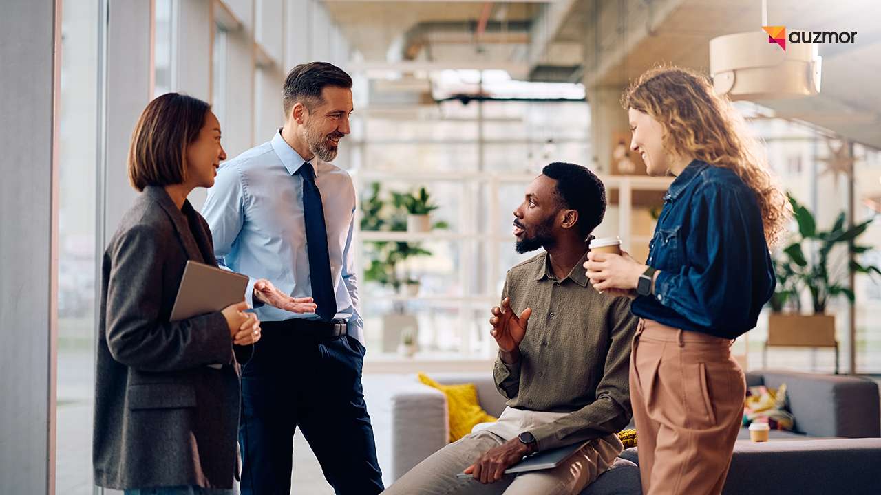 Colleagues having a career conversation in a modern office lounge