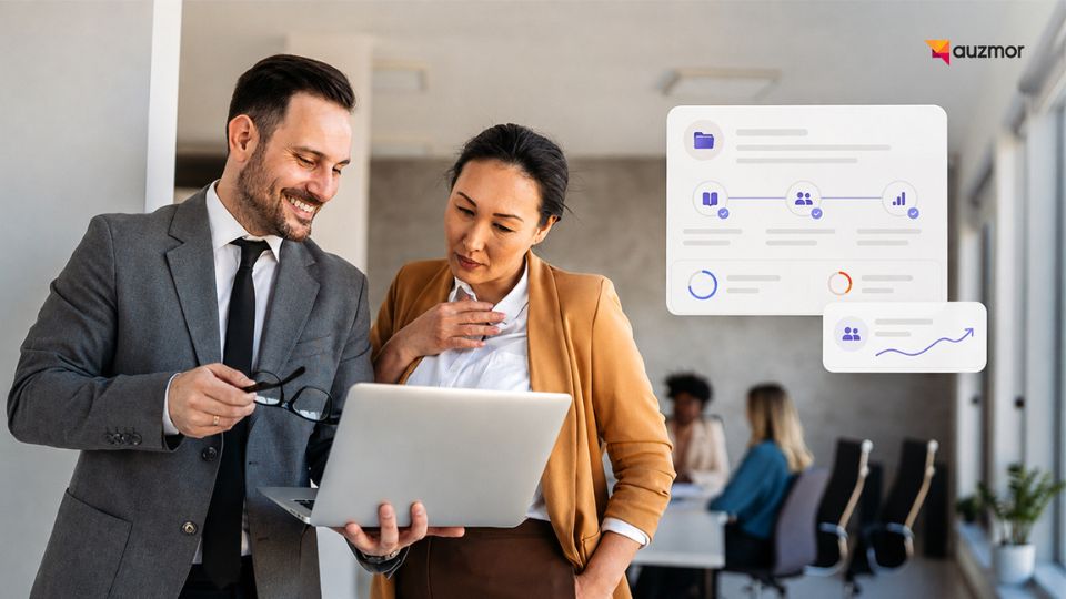 Two colleagues smiling at a laptop beside workflow and analytics panels in an office
