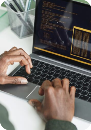 Hands typing code on a laptop during an online course