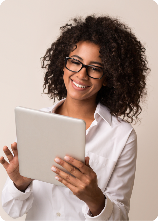 Smiling woman in glasses learning on a tablet