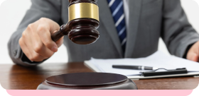 Judge's gavel on a desk, illustrating the cost of non-compliance fines