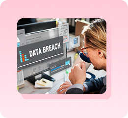 Worker facing a data breach warning on screen, representing the cost of a breach