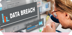 Person looking at a screen reading "Data breach", illustrating the cost of a data breach