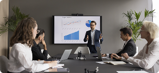 Presenter sharing a sales chart in a meeting, representing business and professional skills training