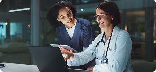 Two doctors reviewing a tablet together, representing industry-specific training for healthcare and more