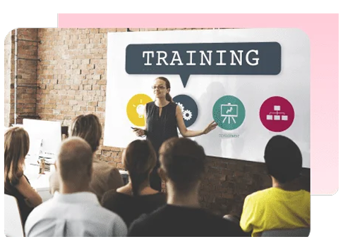 Trainer presenting to a room of employees in front of a Training sign