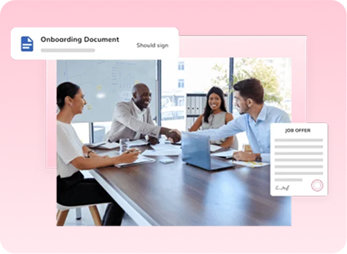Team meeting around a conference table with an onboarding document and job offer card