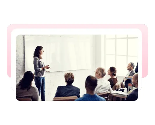 Trainer presenting to a group in a classroom