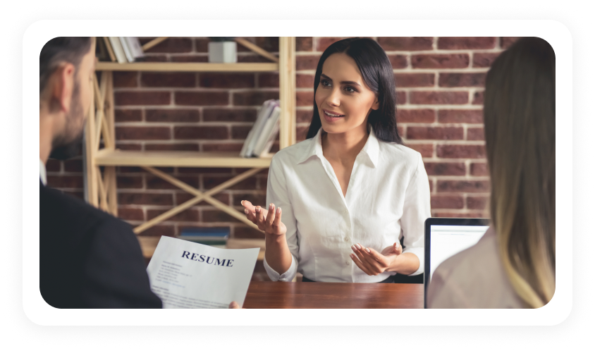 Interviewer reviewing a candidate resume across the desk