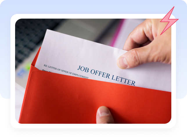 Hand pulling a job offer letter out of a red envelope