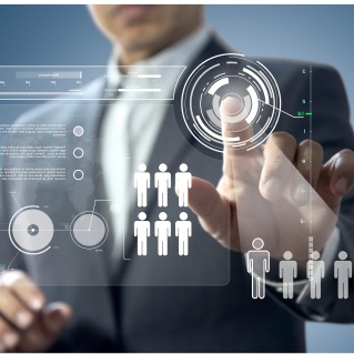 Businessman tapping a digital interface of employee icons to analyze talent needs