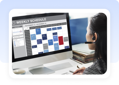 Recruiter wearing a headset reviewing a weekly schedule on a monitor
