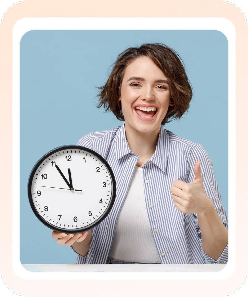 Smiling woman holding a clock and giving a thumbs up