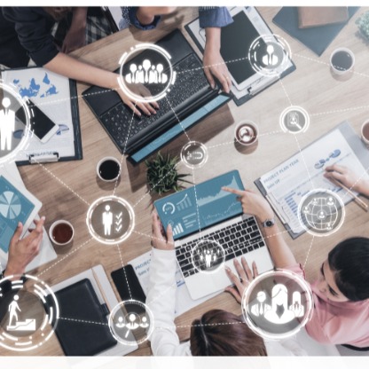 Team at a table with laptops and recruiting icons showing hiring activity