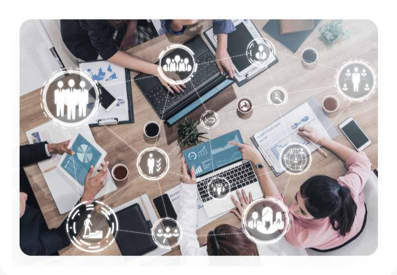 Team at a table with laptops and recruiting icons showing hiring activity