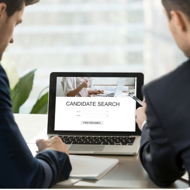 Recruiters reviewing a candidate search on a laptop