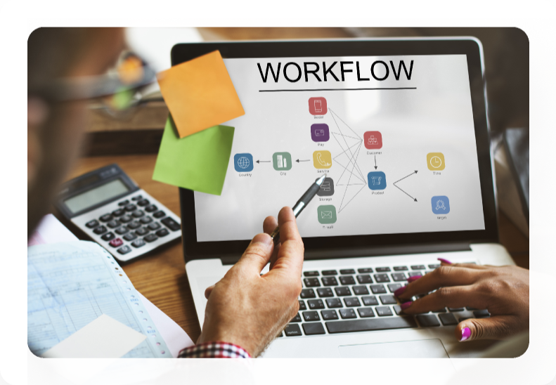 Person mapping a workflow diagram on a laptop screen