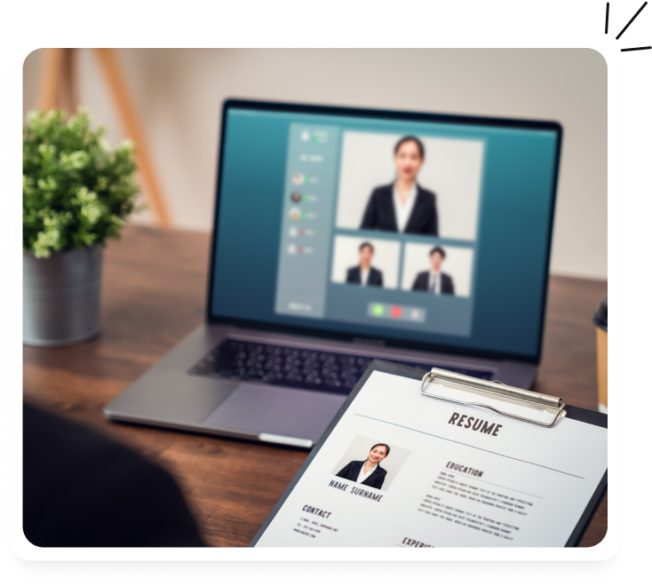 Laptop video call with candidates beside a resume on a clipboard
