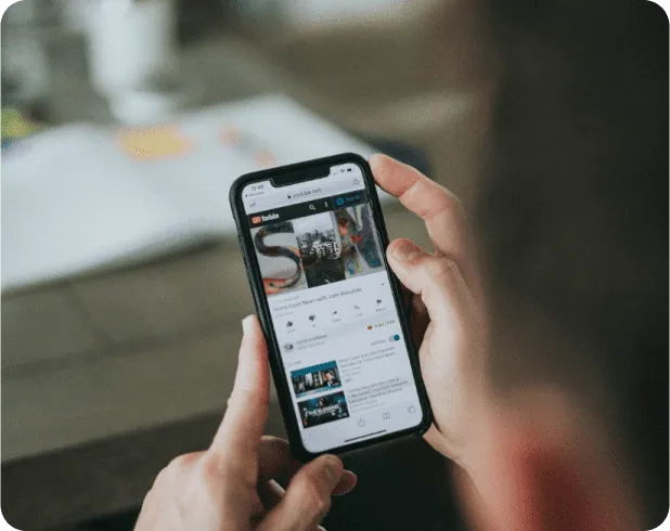 Person holding a smartphone showing a mobile app